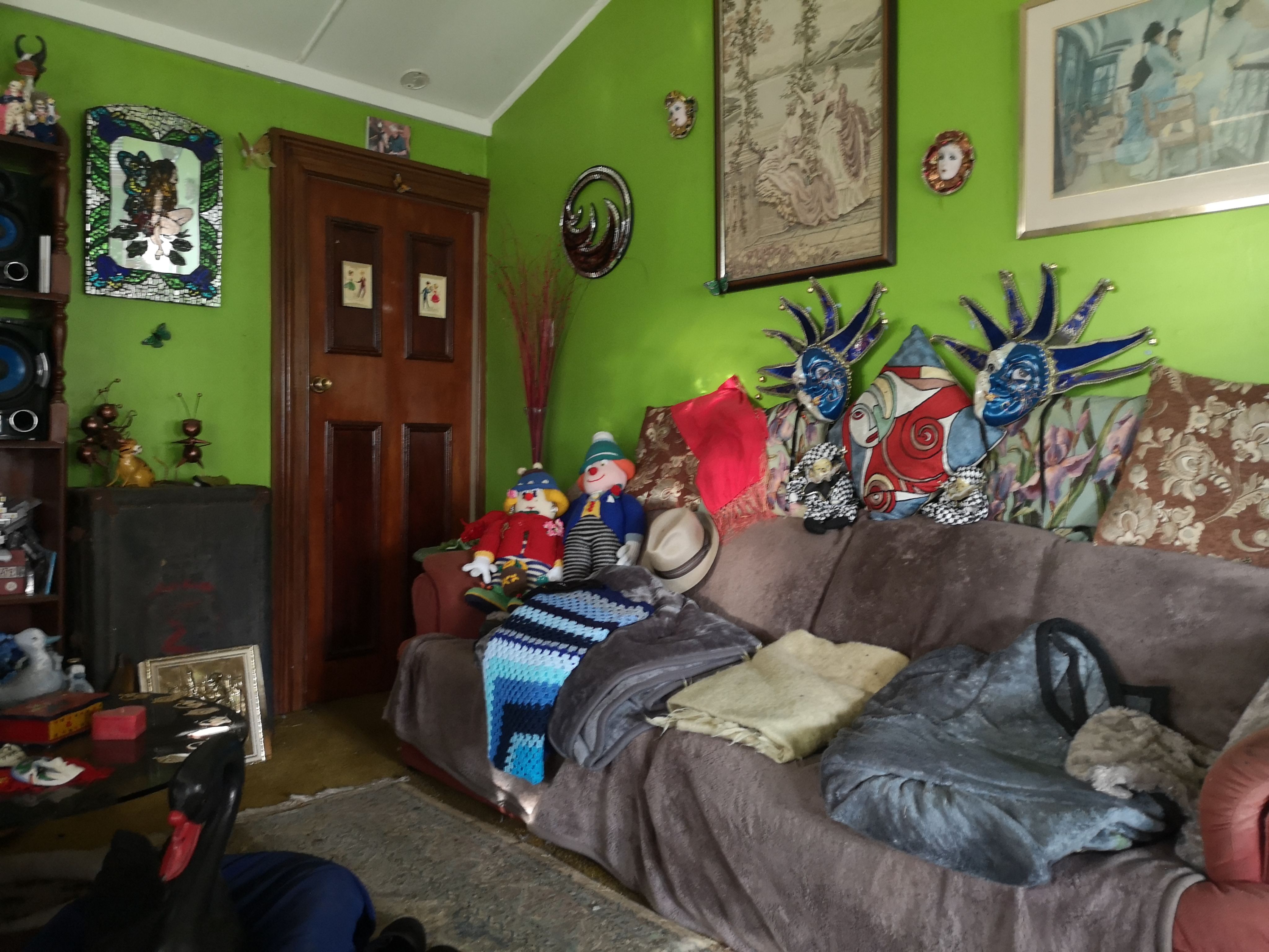 The lime green walls in Peter’s home were covered in artwork.