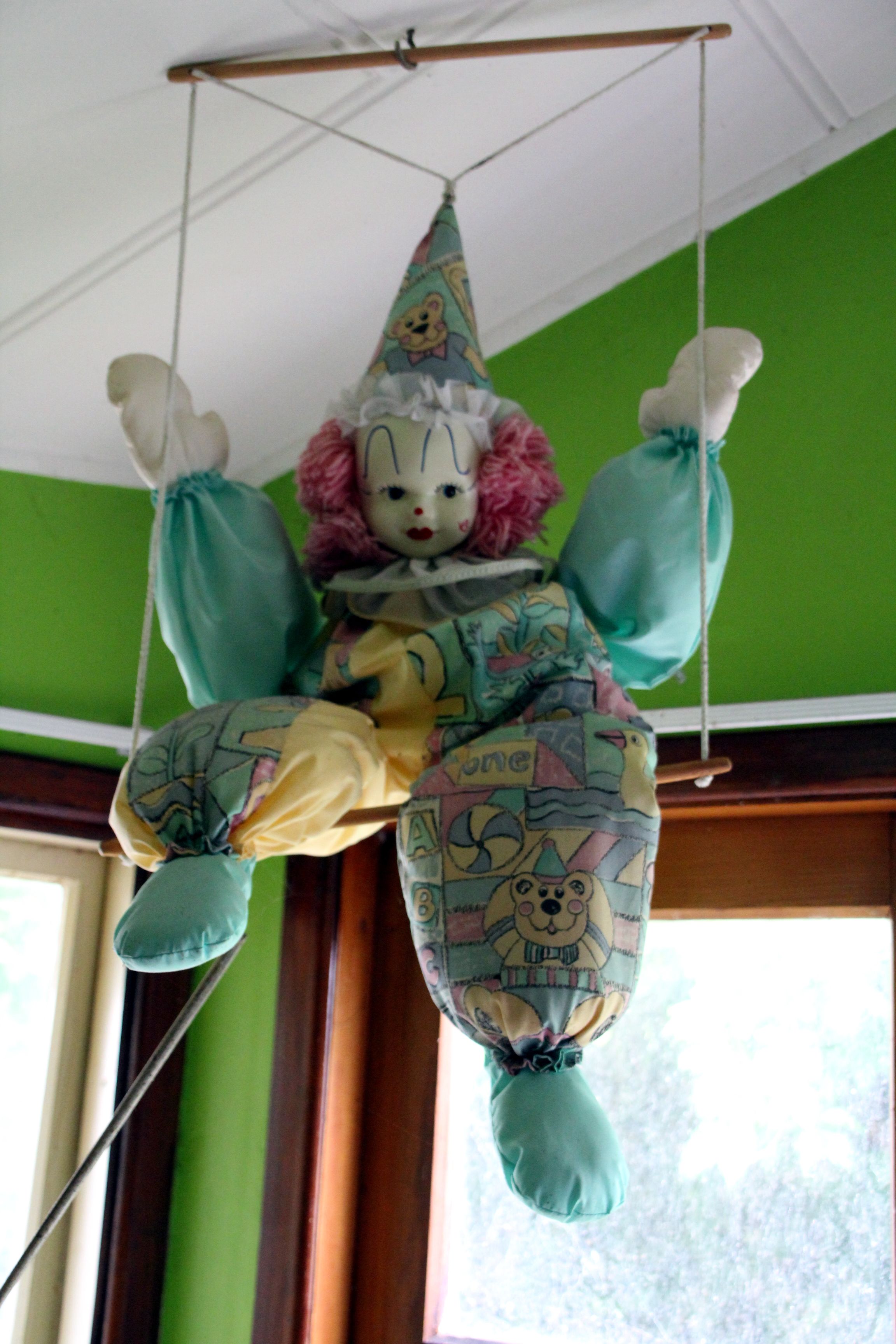 A clown hangs from the ceiling in Peter Ellis’s living room